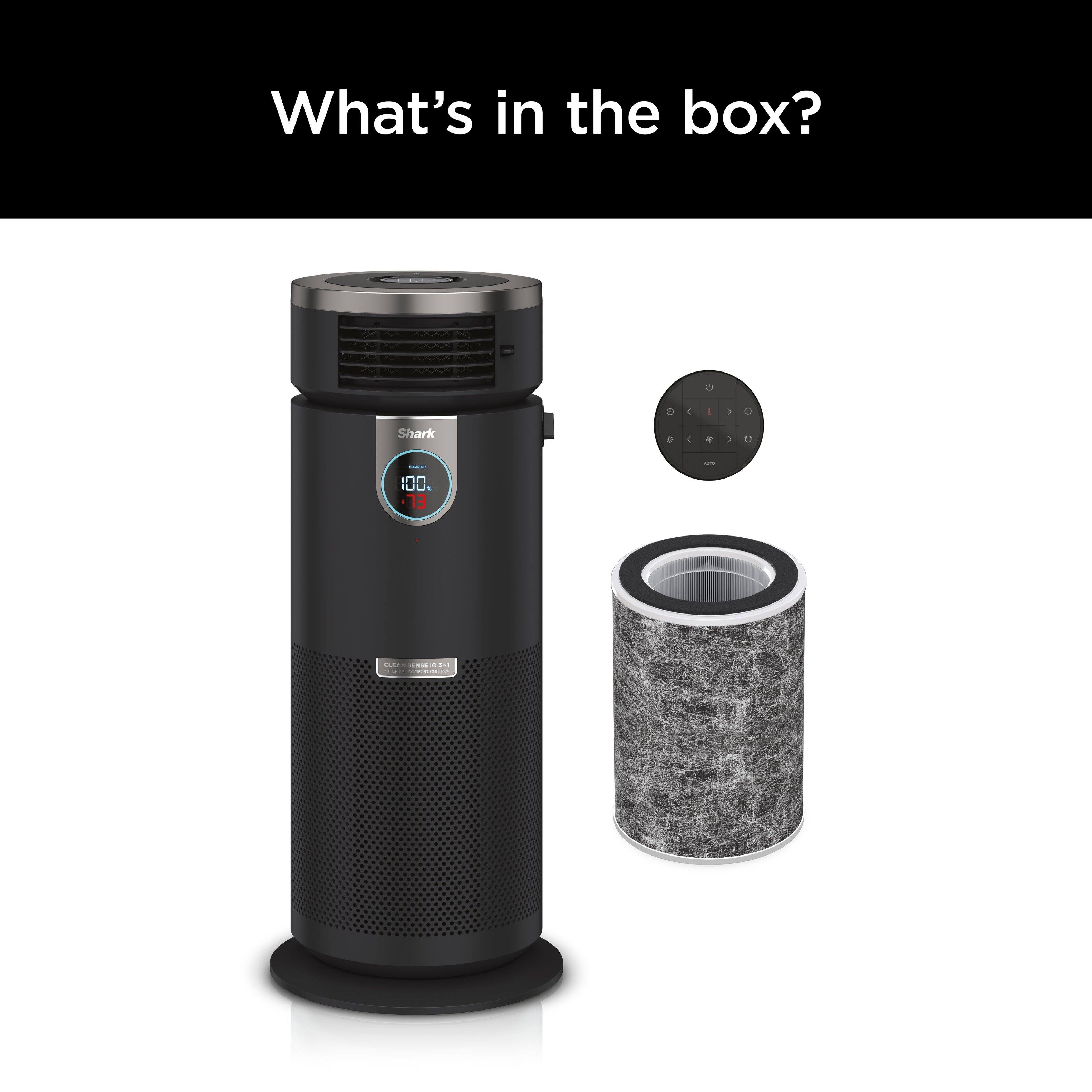 The image features a black Shark IQ robot vacuum cleaner sitting on a white background. The vacuum cleaner is accompanied by a small black and grey accessory, which appears to be a filter. The image does not show any box or additional information about the contents of the box.