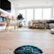 The image shows a robotic vacuum cleaner on a carpeted floor, with a cell phone displaying the robot's status. The robotic vacuum is designed to clean your home, including the playroom, and it can take around 100% of the time to clean your kitchen. The vacuum is equipped with different power levels, including Eco, Normal, and Max, to suit various cleaning needs. The cell phone app allows you to monitor and control the robotic vacuum from your phone, making it a convenient and efficient cleaning solution.