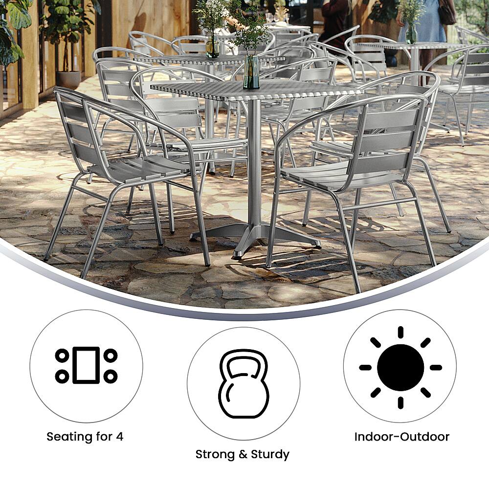 The image showcases a large dining table surrounded by several chairs, with a total of 12 chairs visible. The table is set up for outdoor dining, and the chairs are arranged in a circular fashion. The table is accompanied by a potted plant, adding a touch of greenery to the scene. The chairs are positioned around the table, creating a comfortable and inviting atmosphere for a meal or gathering.