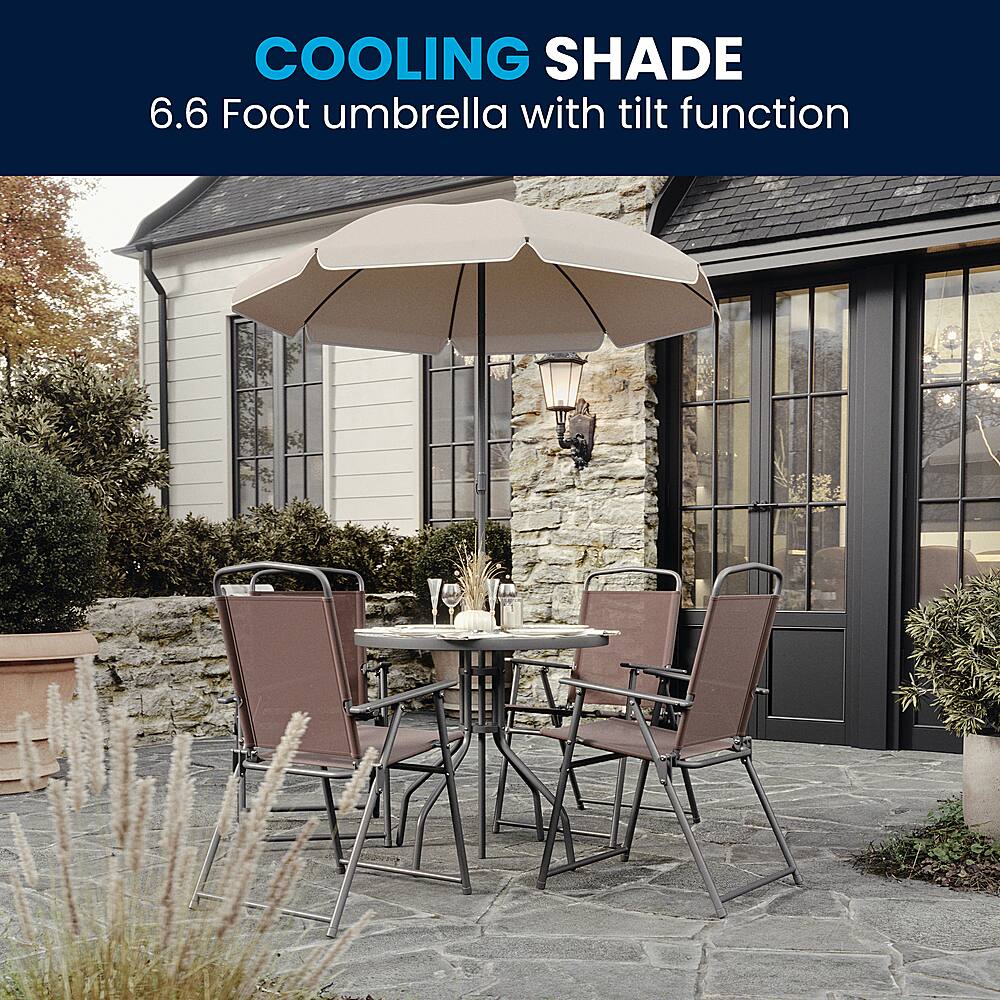 The image features a patio set with a 6.6 foot umbrella that has a tilt function. The umbrella is providing shade to the table and chairs, creating a comfortable outdoor seating area. The table is surrounded by chairs, and there are potted plants nearby, adding to the pleasant atmosphere of the outdoor space.