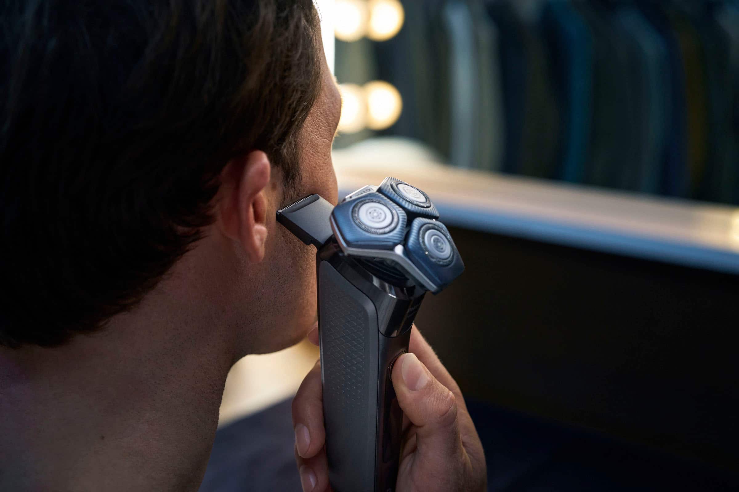 Left. Philips Norelco - Shaver 7600, Rechargeable Wet & Dry Electric Shaver with SenseIQ Technology - Black.