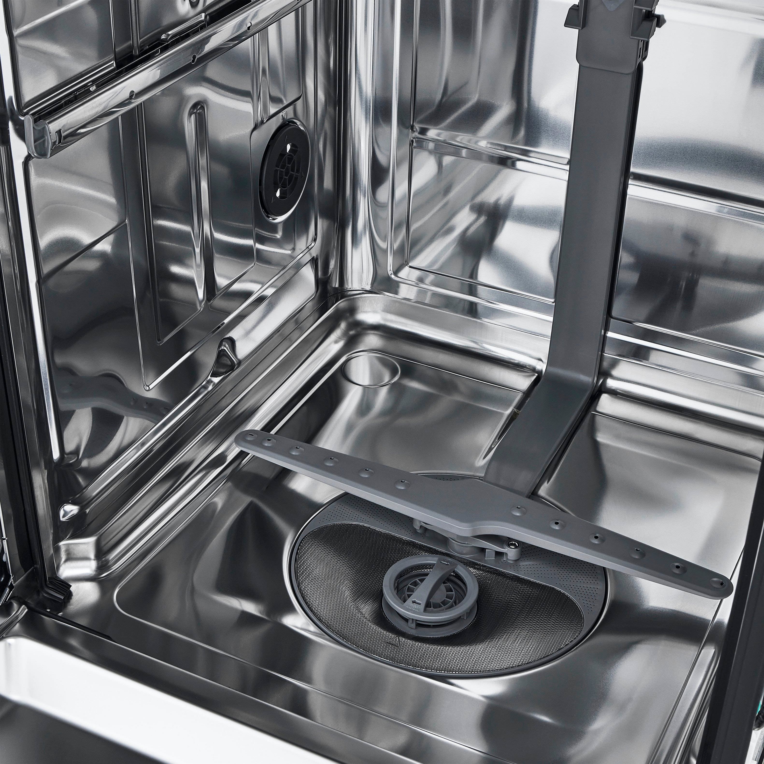 The image features a stainless steel tub, which is a built-in dishwasher. The tub is made of stainless steel, giving it a sleek and modern appearance. The dishwasher is designed to be integrated into the kitchen cabinetry, providing a seamless and space-saving solution for washing dishes. The stainless steel tub is a popular choice for built-in dishwashers due to its durability, ease of cleaning, and resistance to stains and corrosion.