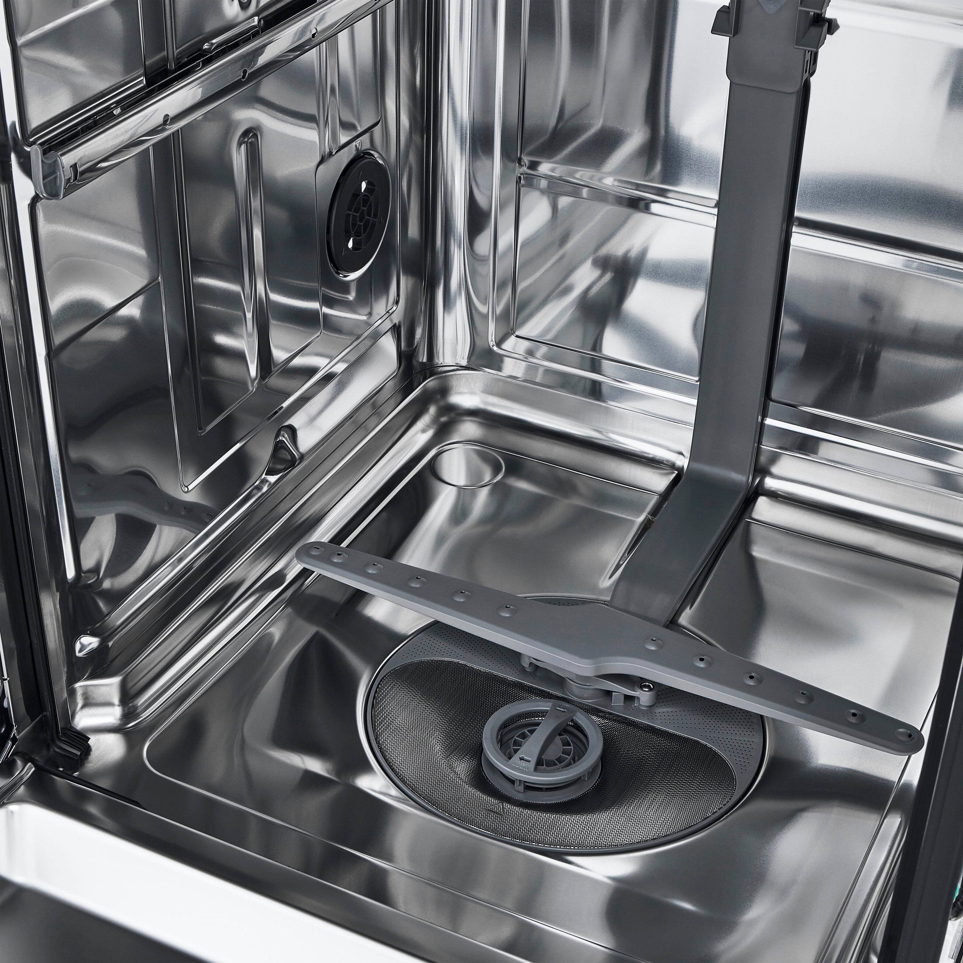 The image features a stainless steel tub, which is a built-in dishwasher. The tub is made of stainless steel, giving it a sleek and modern appearance. The dishwasher is designed to be integrated into the kitchen cabinetry, providing a seamless and space-saving solution for washing dishes. The stainless steel tub is a popular choice for built-in dishwashers due to its durability, ease of cleaning, and resistance to stains and corrosion.