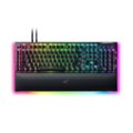 The image features a colorful keyboard with a rainbow design, which includes a variety of colors such as pink, blue, green, and yellow. The keyboard is a black and colorful model, likely a Razer keyboard, with a unique design that makes it stand out. The keys are arranged in rows, and the keyboard is placed on a white background, which further emphasizes the vibrant colors of the keyboard.