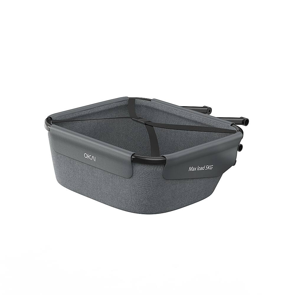 The image features a large gray basket with a black strap, designed for carrying items. The basket is labeled "OKAI" and has a maximum load capacity of 5 kg. The basket is placed on a white background, which highlights its color and design.