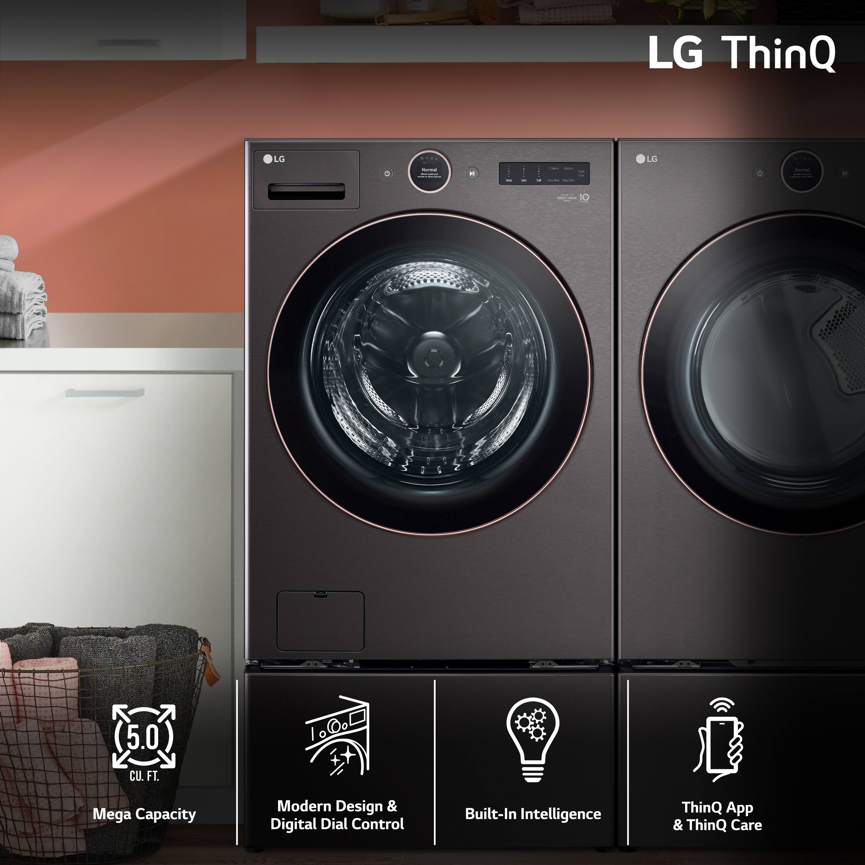 The image features a front-load washer and dryer set by LG. The washer has a large capacity and a modern design with a digital dial control. The dryer is also a part of the set, and it is equipped with built-in intelligence. The LG ThinQ app and ThinQ Care are also available for this appliance, providing additional convenience and control. The washer and dryer are placed in a room with a pink wall, and there is a refrigerator nearby.