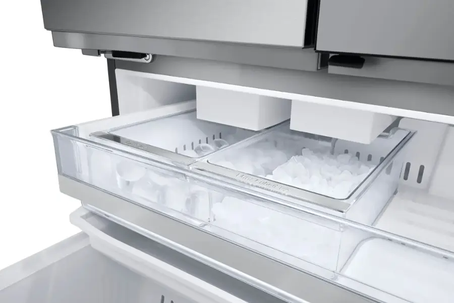 The image features a large, modern refrigerator with a capacity of 26 cubic feet. It is designed with a counter-depth style, which means the refrigerator is built into the countertop, creating a sleek and seamless appearance. The refrigerator is placed in a kitchen setting, with a marble countertop and a shelf above it. The refrigerator is the main focus of the image, and it is likely being advertised as a space-saving solution for those with limited kitchen space.