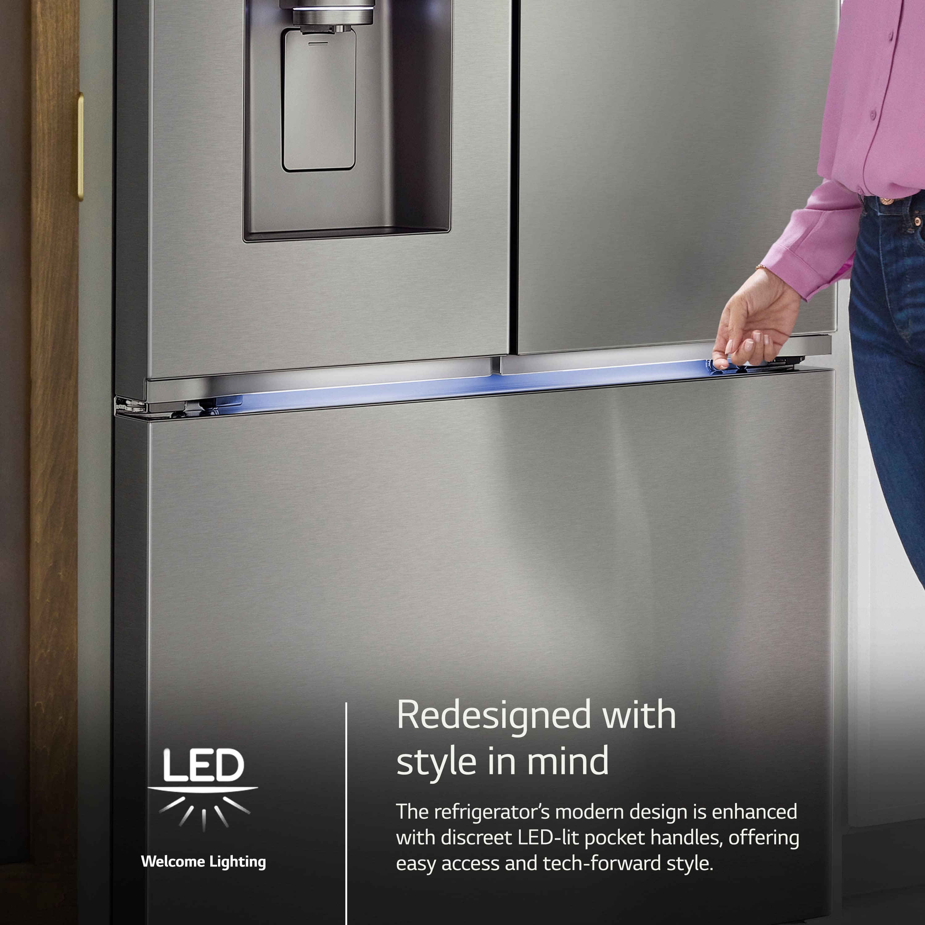 Zoom in on The image features a person opening a refrigerator with a modern design. The refrigerator is redesigned with style in mind, and it has LED-lit pocket handles that offer easy access and a tech-forward style. The refrigerator is also equipped with a water dispenser, making it a convenient and functional appliance.