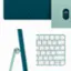 The image features a green keyboard with a detachable mouse. The keyboard is a part of an all-in-one desktop computer. The keyboard has a numeric keypad and a set of function keys. The detachable mouse is connected to the keyboard, allowing for easy use and portability.