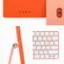 The image showcases a pink keyboard and mouse, which are part of an all-in-one desktop computer. The keyboard has a clean and minimalist design, with a focus on functionality. The mouse is also pink and matches the keyboard in terms of color and style. The combination of the keyboard and mouse creates a cohesive and visually appealing setup for the user.