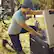 The woman is kneeling down next to a Dometic CFX cooler.
