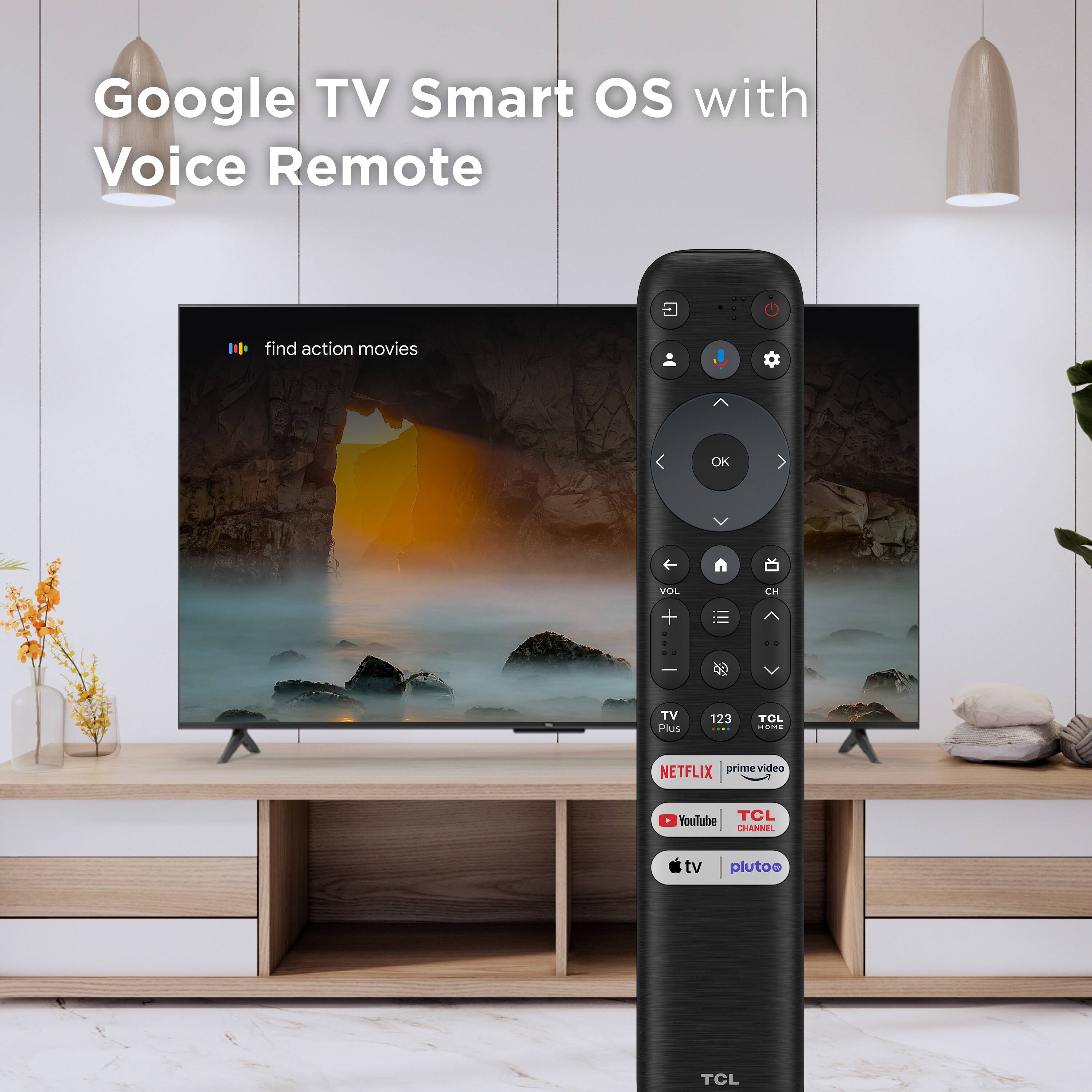 The image features a large flat screen TV with Google TV Smart OS and Voice Remote. The TV is displaying a movie scene, and there is a remote control in front of it. The remote control has various buttons, including a Netflix button, a Prime Video button, and a YouTube button. The TV is placed on a wooden stand, and there is a potted plant nearby.