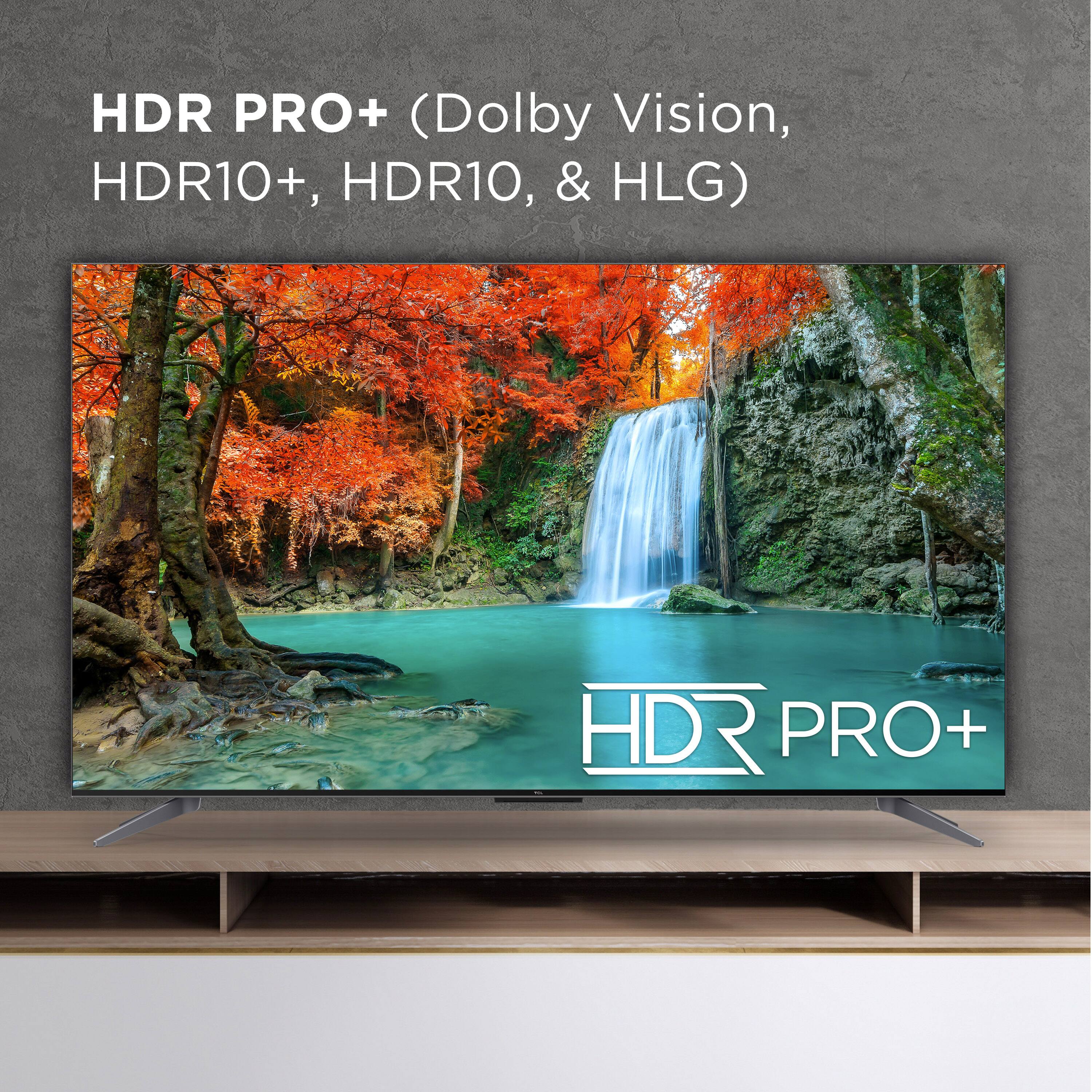 The image features a large flat screen television with a beautiful scene of a waterfall and a forest in the background. The TV is described as an HDR PRO+ television, which indicates that it supports various high-definition technologies such as Dolby Vision, HDR10+, HDR10, and HLG. This suggests that the television is capable of displaying high-quality visuals with enhanced color accuracy and contrast, providing an immersive viewing experience for the viewer.