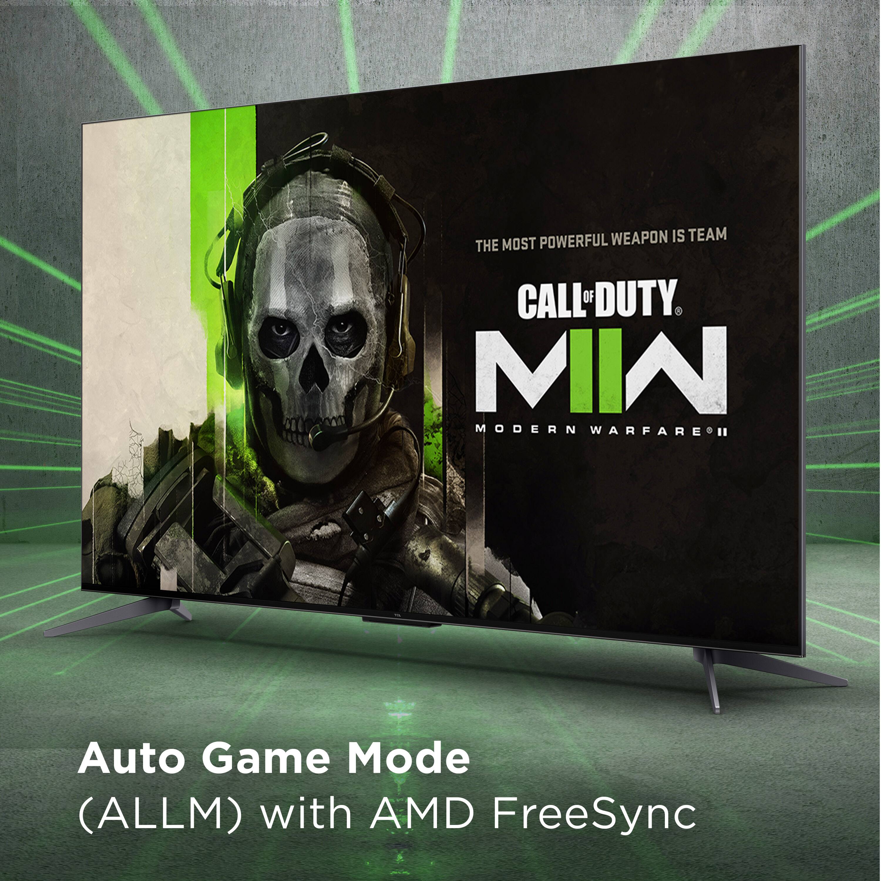 The image features a large flat screen TV with a Call of Duty Modern Warfare advertisement displayed on it. The advertisement showcases a man with a skull on his face, emphasizing the powerful weapon in the game. The TV is positioned on a stand, and the advertisement is promoting the game's auto game mode, which is compatible with AMD FreeSync technology.