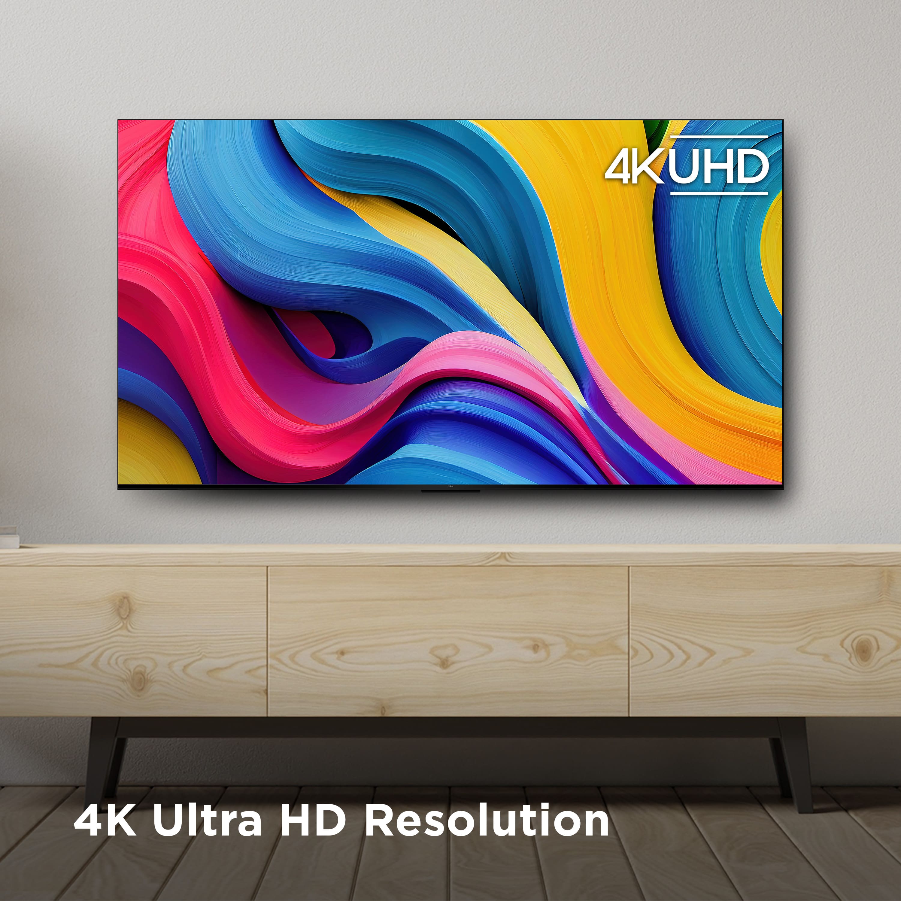 The image features a large flat screen television mounted on a wall. The TV is advertised as having a 4K Ultra HD resolution, which is the largest text displayed in the image. The television is placed on a wooden stand, and the wall behind it is white. The advertisement emphasizes the high-quality resolution of the TV, making it an attractive choice for viewers looking for an immersive and detailed viewing experience.