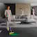 Clean up high: The woman is holding a vacuum cleaner and cleaning the ceiling.
Clean everywhere in between: The woman is cleaning the floor in between the couches.
Deep clean carpets: The woman is cleaning the carpet on the floor.
Deep cleans hard floors: The woman is cleaning the hard floors in the room.