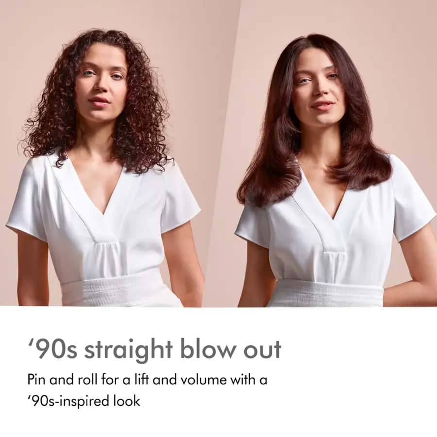 The image features two women with curly hair, showcasing a '90s straight blow out hairstyle. The hairstyle is achieved by using a pin and roll technique for added lift and volume, resulting in a voluminous and stylish look. The women are wearing white shirts, further emphasizing the '90s-inspired theme of the hairstyle.