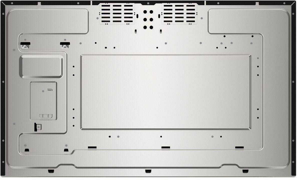 The image features a white microwave oven with a black door. The microwave is turned off, and the door is open. The time displayed on the microwave is 12:03.