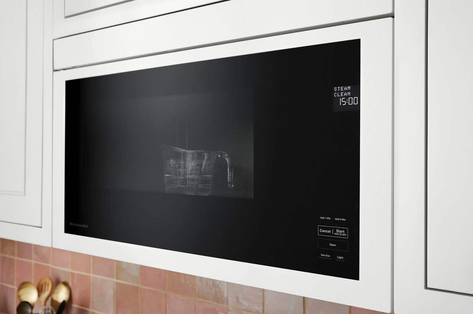 The image features a microwave oven with a black door and a black interior. The microwave is empty, with no food or items inside. It is a modern and sleek appliance, suitable for various cooking and heating tasks.