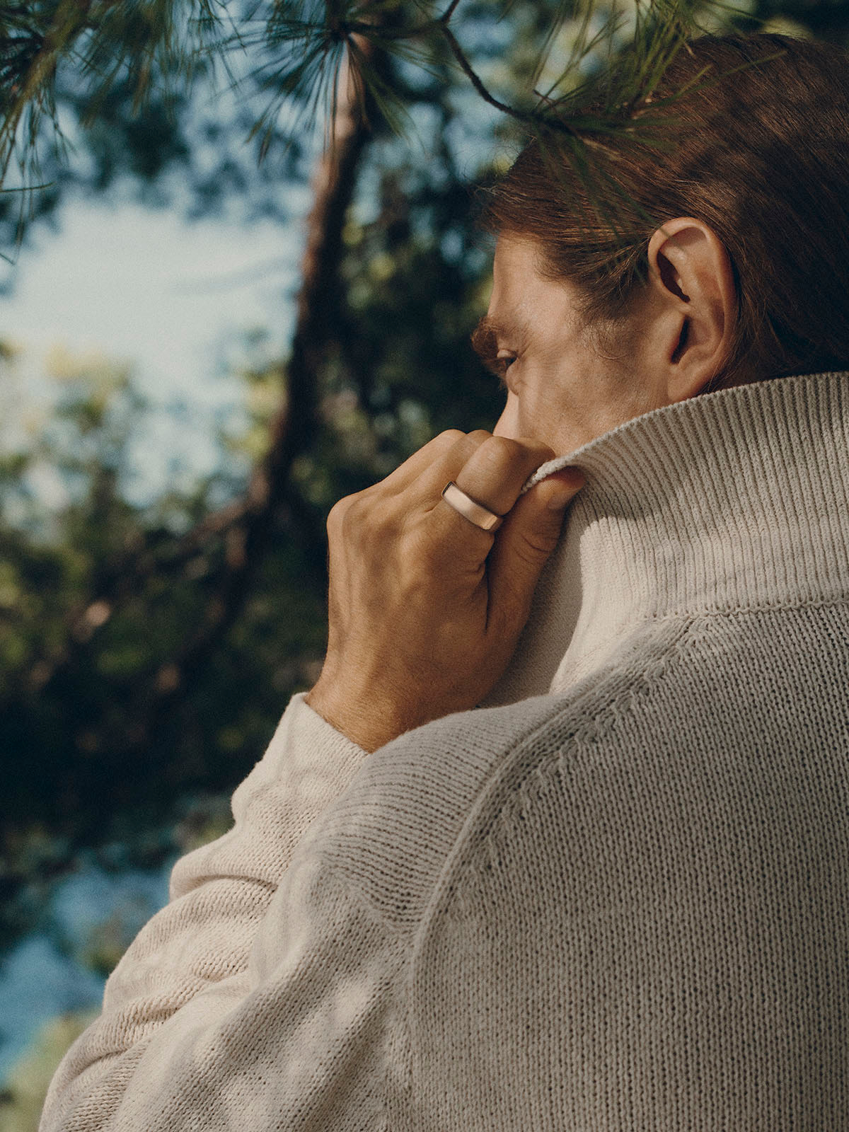 The man in the image is wearing a ring, and the text on the screen indicates that the Oura Ring is eligible for reimbursement with HSA and FSA. This means that the ring can be covered by health savings accounts and flexible spending accounts, depending on the administrator's coverage. The man is wearing a gray suit, and the image is a close-up of his face and hands.