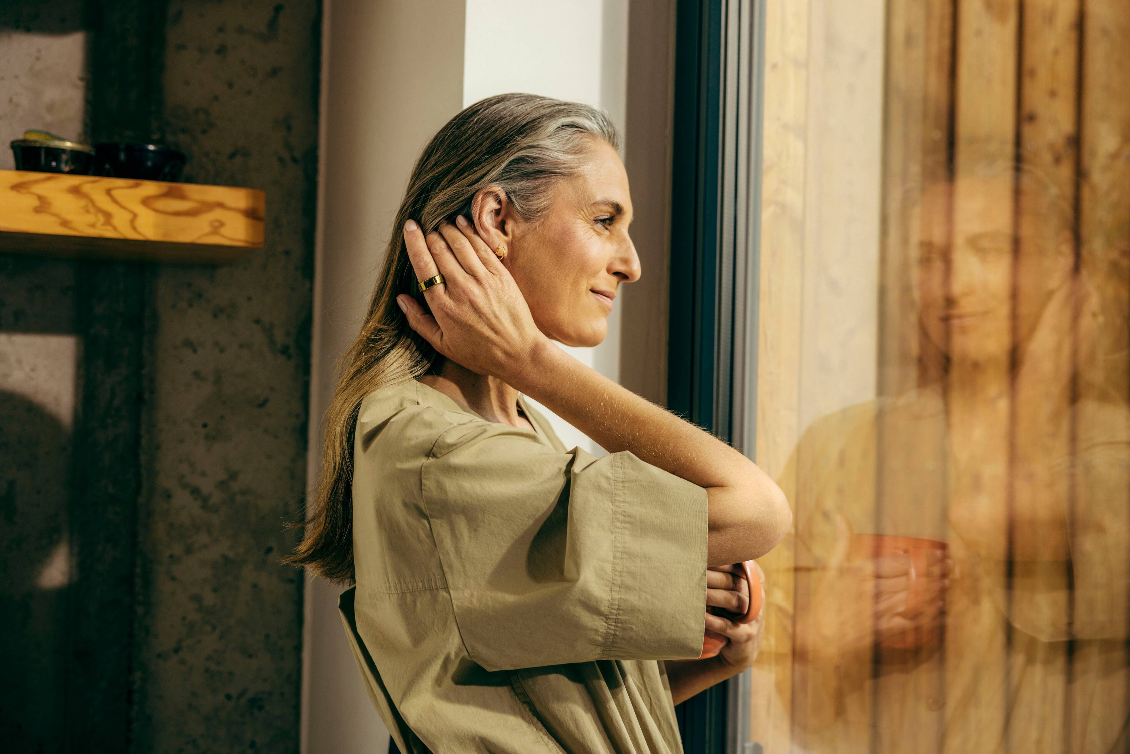 The image features a ring and a charger, with the ring being a gold ring and the charger being a USB cable. The ring is described as a "Oura Ring Gen3," while the charger is labeled as a "USB Cable." The ring and charger are placed next to each other, and the ring is also shown in a close-up view.