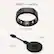 The image shows a black ring and a USB cable, with the ring being described as a "smart ring." The ring is placed next to the USB cable, which is connected to a charger. The ring is also referred to as an "Oura Ring Gen3."