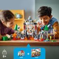 The image features a boy and a girl sitting at a table, playing with Lego blocks and building sets. They are surrounded by various Lego pieces, including a castle and a dragon. The table is filled with different Lego sets, and the children appear to be enjoying their time together. The image is categorized as Blocks_and_Building_Sets.
