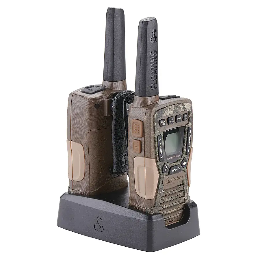 The image features two waterproof cell phones, one of which is a floating phone, sitting on a charging station. The phones are designed to be used in water and are equipped with antennas. The charging station is made of plastic and is designed to hold the phones securely while they are charging. The phones are placed on the charging station, ready for use or recharging.