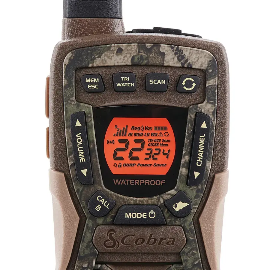 The image features a camouflage-patterned radio, which is waterproof and has a variety of functions. The radio has a clock on its face, and it is equipped with a scan feature that allows the user to search for channels. The radio also has a watch function, which can be used to keep track of time. Additionally, the radio has a power saver mode to conserve battery life. The radio is designed by Cobra, a well-known brand in the field of communication devices.