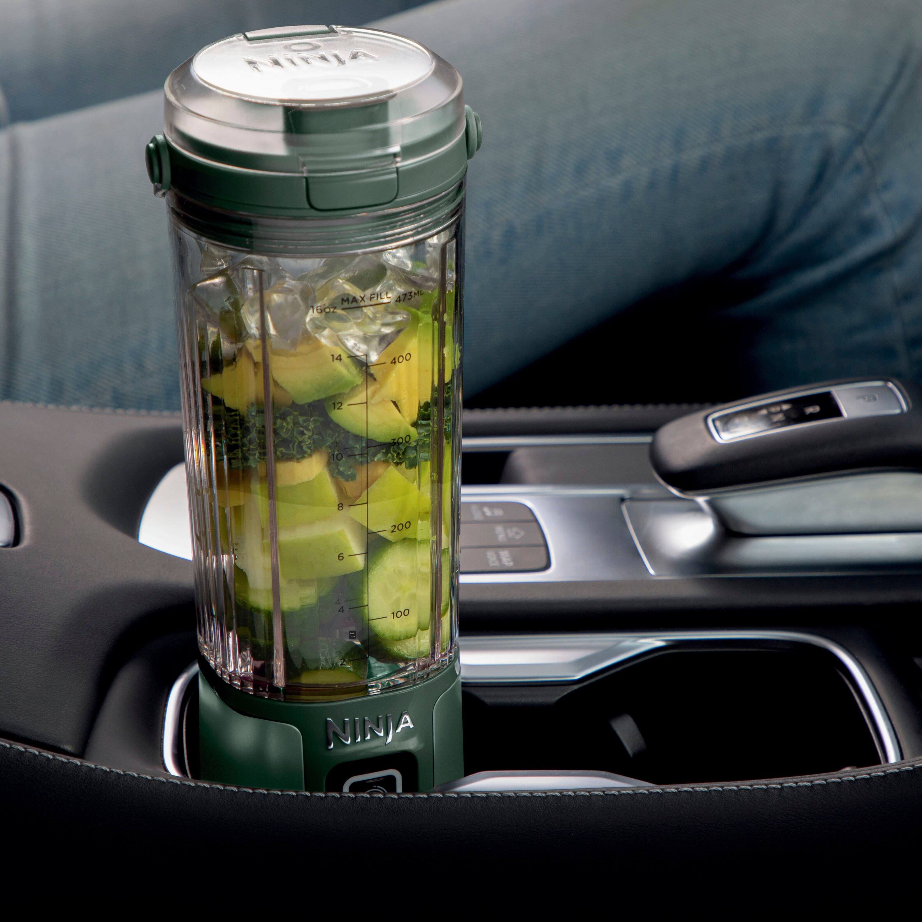 The image features a Ninja blender sitting in a car cup holder, making it a convenient and portable option for travel. The cup holder is designed to fit comfortably in the car, providing a convenient and portable solution for blending and enjoying smoothies on the go.