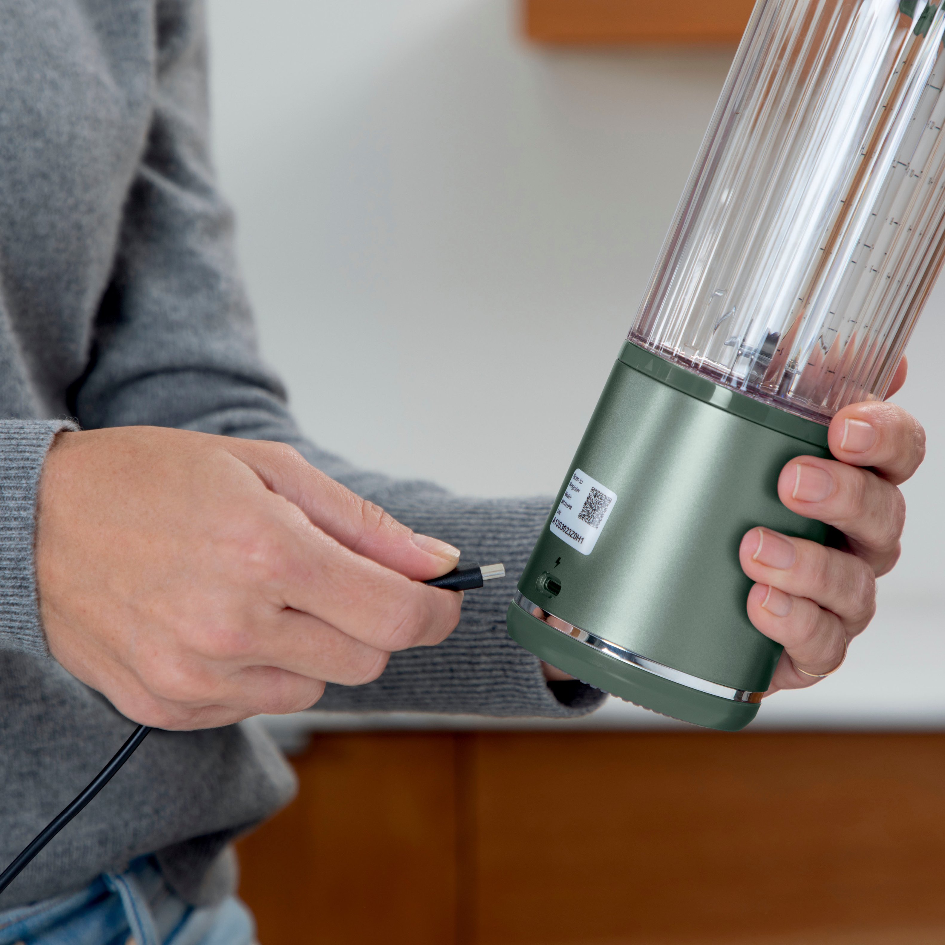 The image features a person holding a green rechargeable power base, which is a portable and convenient device that delivers power and speed without the need for a cord. The power base is compatible with USB-C, making it a versatile and efficient option for charging and powering various devices.