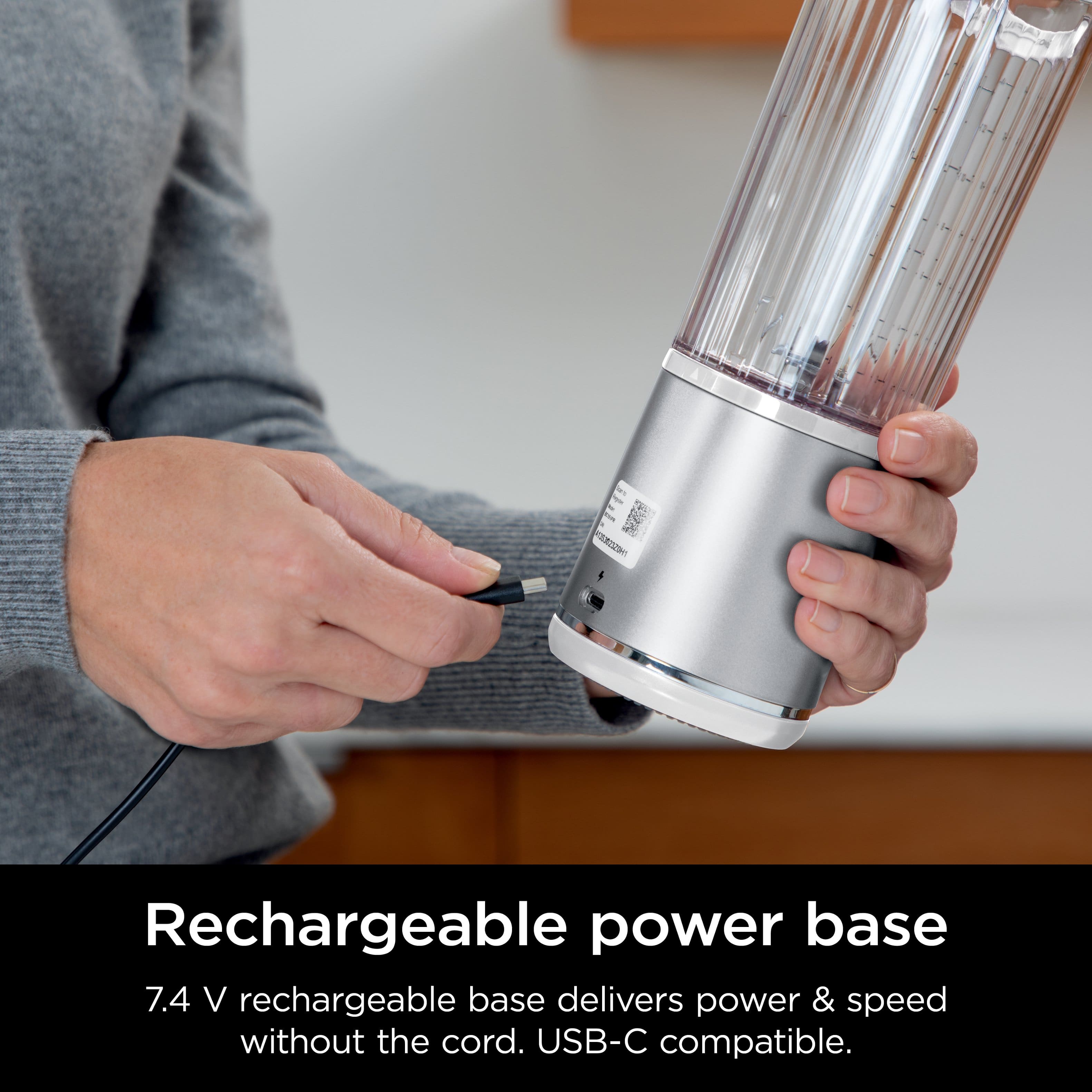 The image features a person holding a rechargeable power base, which is a portable and convenient device that provides power and speed without the need for a cord. This device is compatible with USB-C and can be used to charge various devices, such as smartphones and tablets. The rechargeable power base is a great solution for people who want to stay connected and charged on the go without having to worry about finding an outlet or carrying a bulky charger.