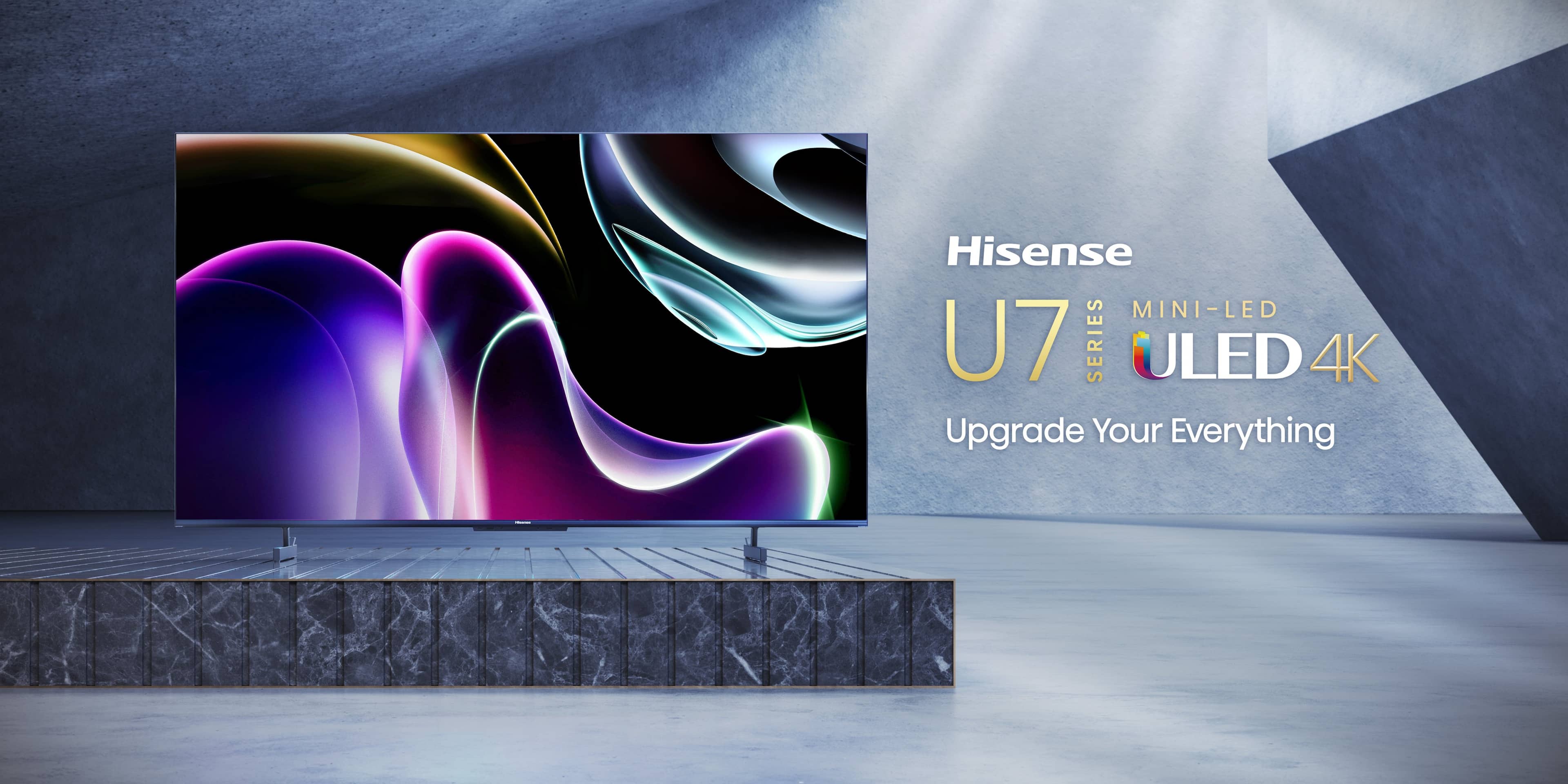 The image features a large Hisense U7 Series ULED 4K television. The TV is displayed in a dark room with a stone wall, and it is positioned on a stand. The television is prominently featured in the image, showcasing its impressive size and quality. The advertisement for the TV emphasizes its ability to upgrade the viewer's experience, making it an attractive option for those looking to enhance their entertainment setup.