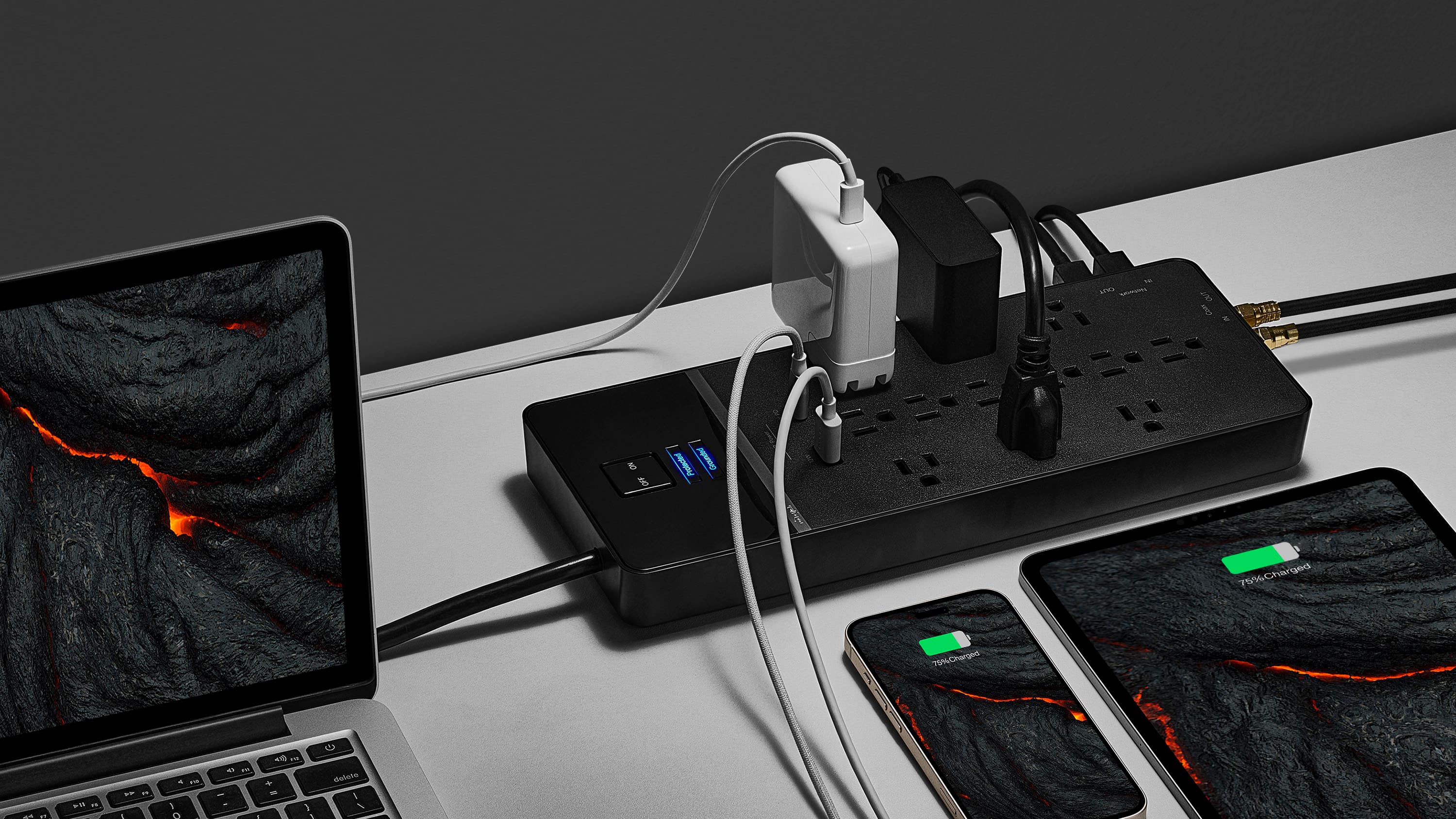 The image features a laptop, a cell phone, and a charger on a table. The laptop is open, and the cell phone is placed next to it. The charger is connected to the laptop and the cell phone, indicating that they are being charged. The laptop is connected to the charger, and the cell phone is also connected to the charger. The scene suggests that the laptop and cell phone are being charged simultaneously, possibly for efficient use of the charger or for convenience.