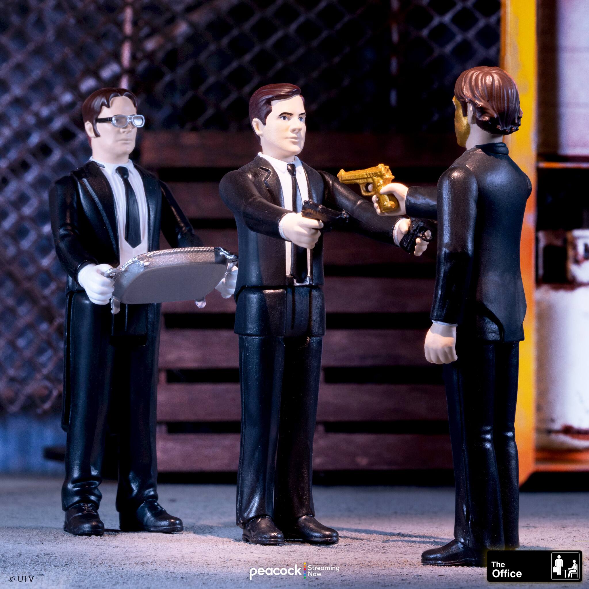 The Office Action Figures:

1. Man with a gun
2. Man with a tray
3. Man with a tie

These action figures are posed in a scene where one figure is holding a gun, another is holding a tray, and the third figure is wearing a tie. The figures are set up in a way that suggests they are reenacting a scene from the TV show "The Office."