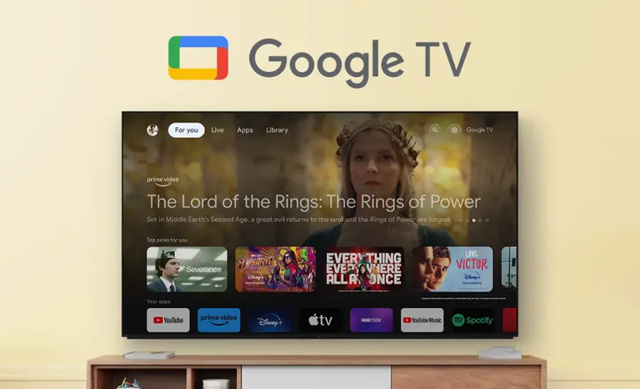 Google TV is a streaming service that offers a variety of content, including movies, TV shows, and live TV. In the image, the Google TV home screen is displayed on a large screen TV, showcasing the available content. The screen features a selection of popular shows and movies, such as "The Lord of the Rings: The Rings of Power" and "Severance." Additionally, there are several other apps available on the Google TV platform, including YouTube, Prime Video, Disney+, and Spotify.