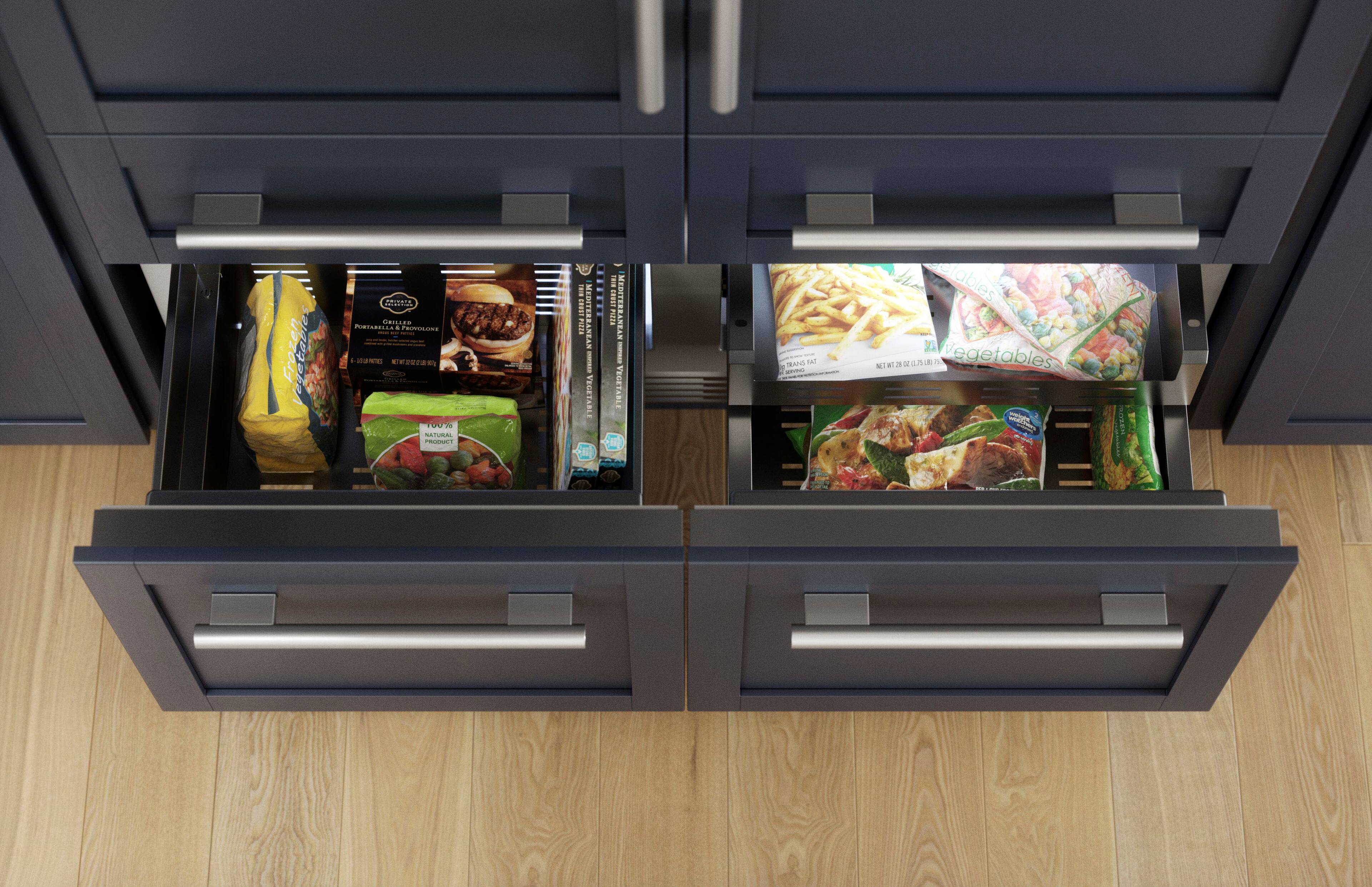The image shows a kitchen with two open drawers, each containing a variety of food items. The drawers are filled with different types of food, including vegetables and frozen establishments. The contents of the drawers are organized in a way that makes it easy to find and access the desired items. The image showcases a well-stocked kitchen with a diverse selection of food options.