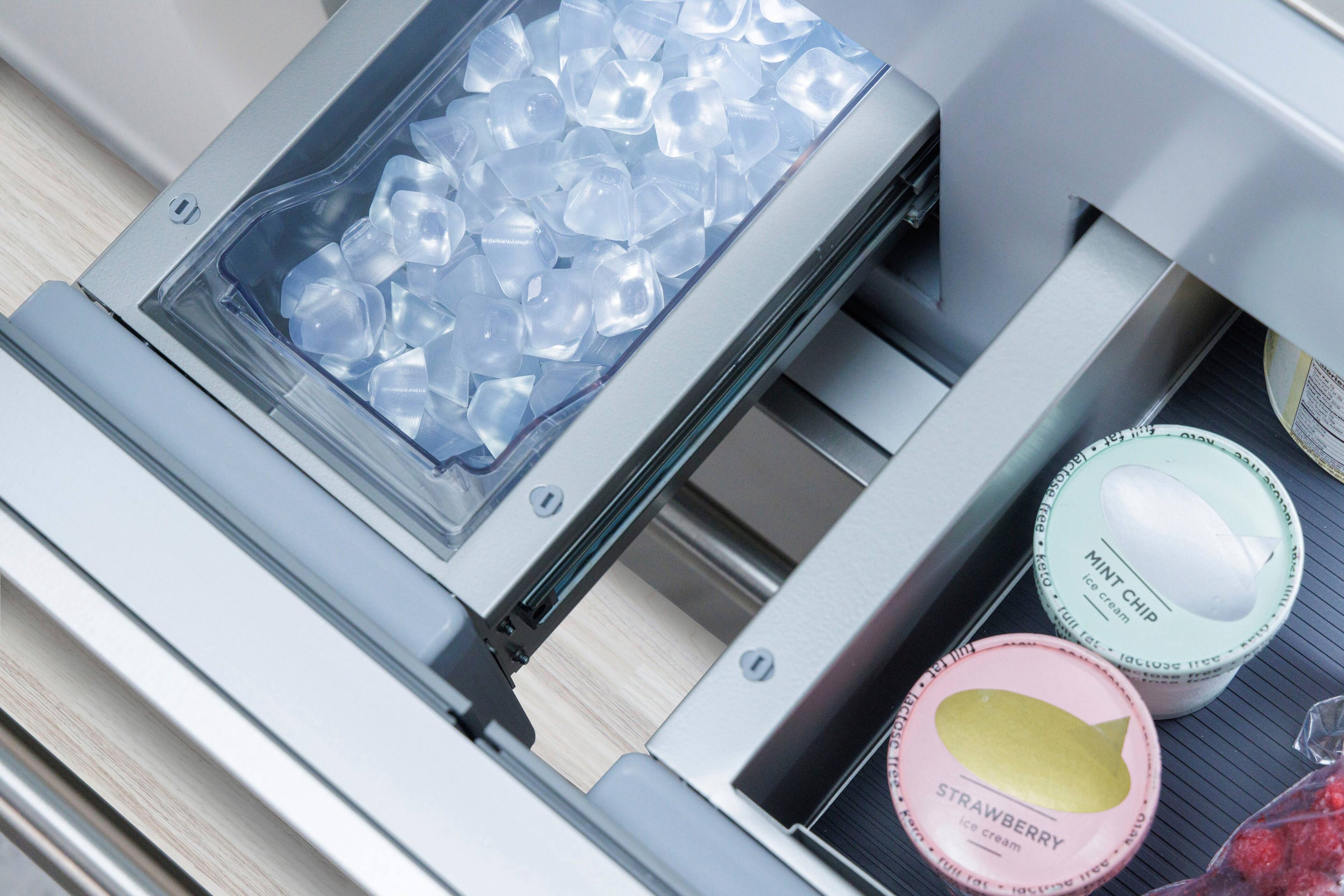 The image shows a refrigerator with a drawer containing several containers of ice cream. There are three containers of ice cream visible, with one on the left side, one in the middle, and another on the right side. The containers are placed in a neat and organized manner, making it easy to access and enjoy the ice cream.