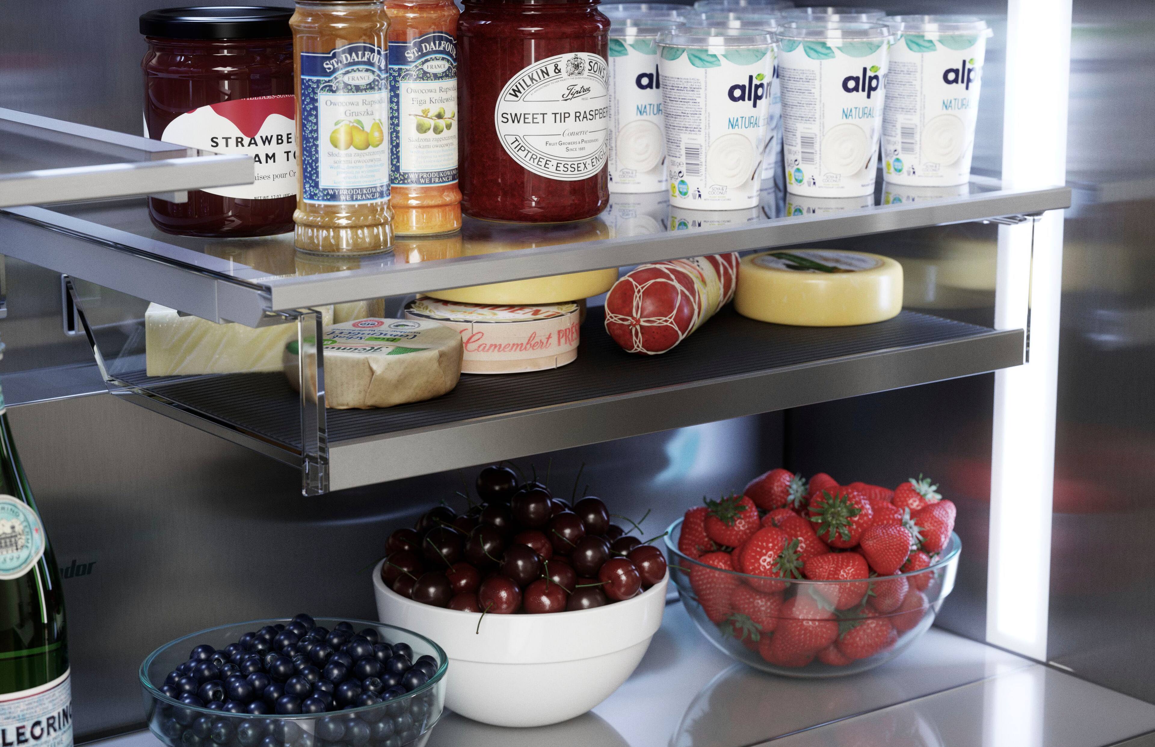 The image shows a refrigerator filled with various food items, including a bowl of cherries, a bowl of strawberries, and a bottle of wine. The refrigerator also contains jars of jam and jelly, as well as several bottles of water. The refrigerator is well-stocked and organized, making it easy to find and access the desired items.