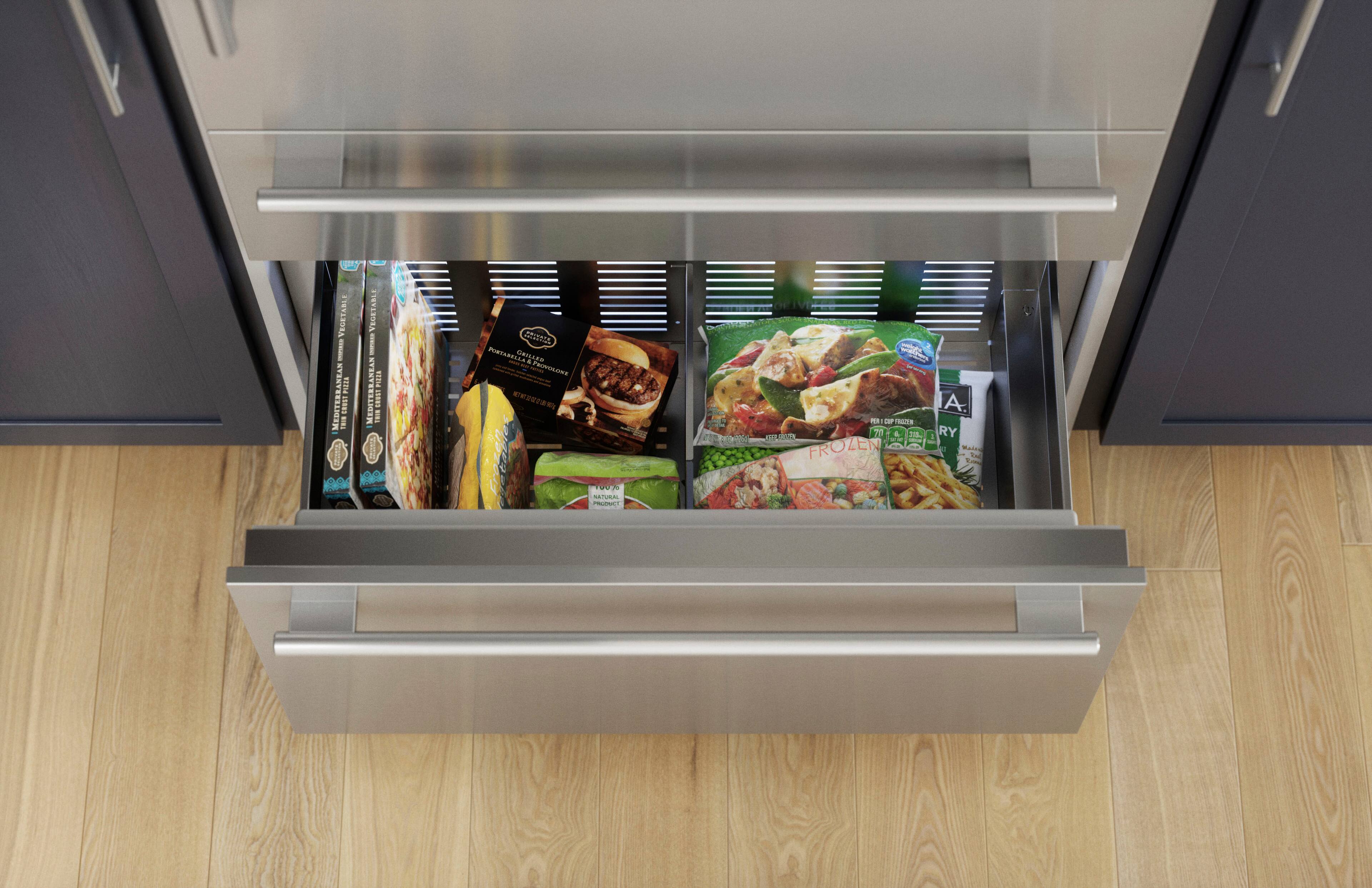 The image features a refrigerator with a drawer open, revealing a variety of food items. There are several pizzas, including a Mediterranean pizza, and multiple sandwiches stored in the drawer. The refrigerator is filled with a diverse assortment of food, making it a convenient and well-stocked appliance for meal preparation.