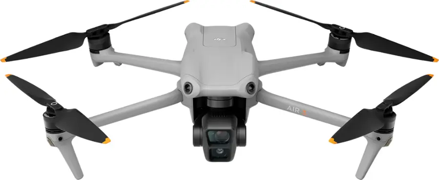 The image features a white drone with four propellers, which is an unmanned aerial vehicle (UAV). The drone is equipped with a camera, making it suitable for aerial photography and surveillance tasks. The UAV is designed to be compact and efficient, with its four propellers providing the necessary lift and maneuverability for flight.