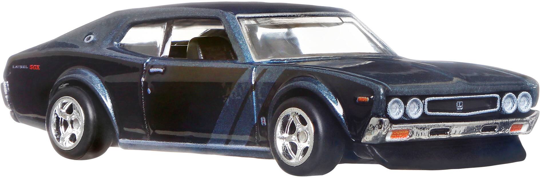 The text "LAUREL SGX L" is not present in the image. The image features a black car with a long hood and a white license plate.