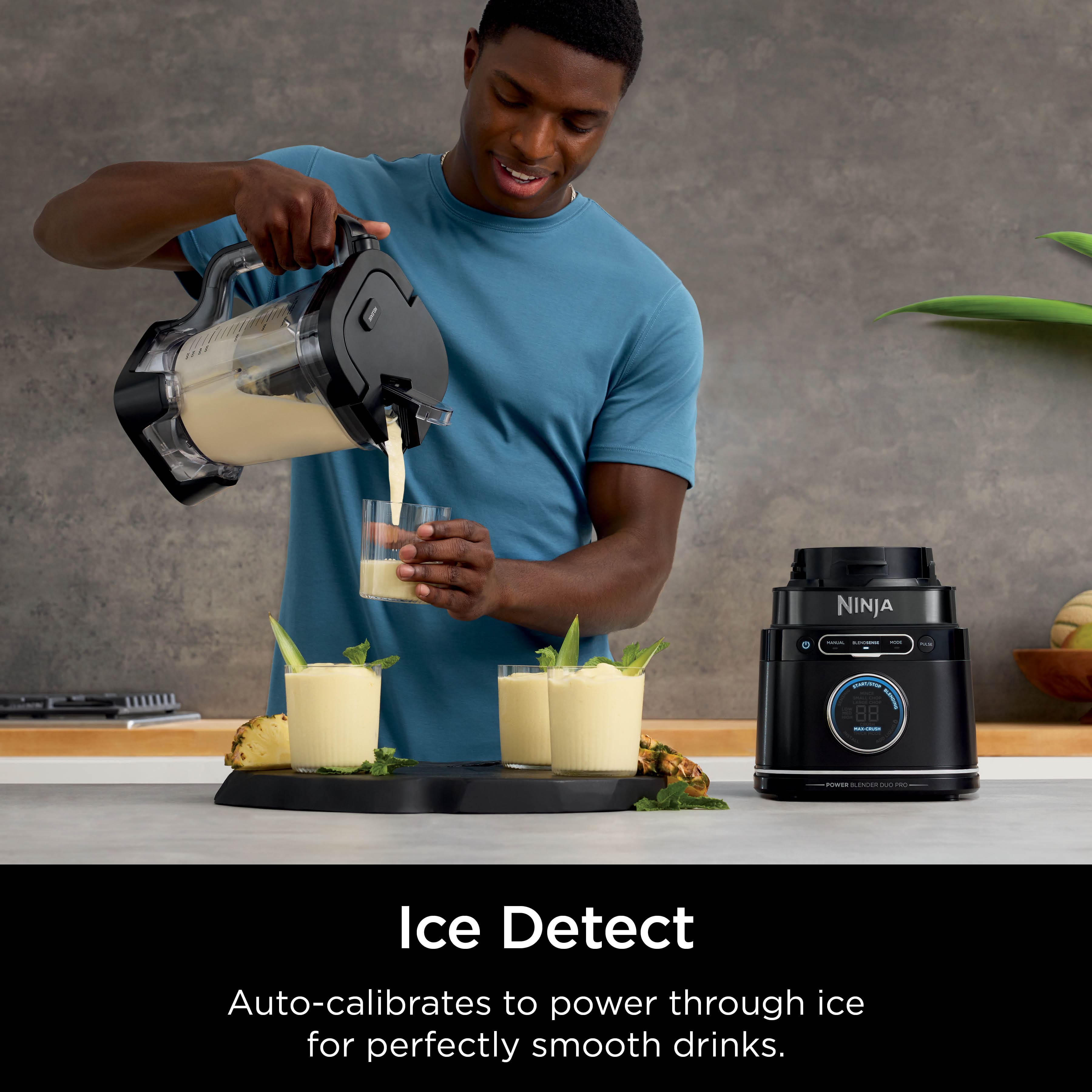 The image features a man pouring a drink into a glass, with a Ninja blender nearby. The blender is designed to auto-calibrate to power through ice for perfectly smooth drinks, making it an ideal choice for creating delicious and refreshing beverages.