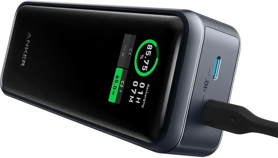 The image features a person holding a portable power pack, which is advertised as having a capacity of 12,000 mAh. The power pack is likely used for charging electronic devices, such as smartphones or tablets, when a traditional power outlet is not available. The person's hand is prominently visible in the image, emphasizing the size of the power pack and its portability.