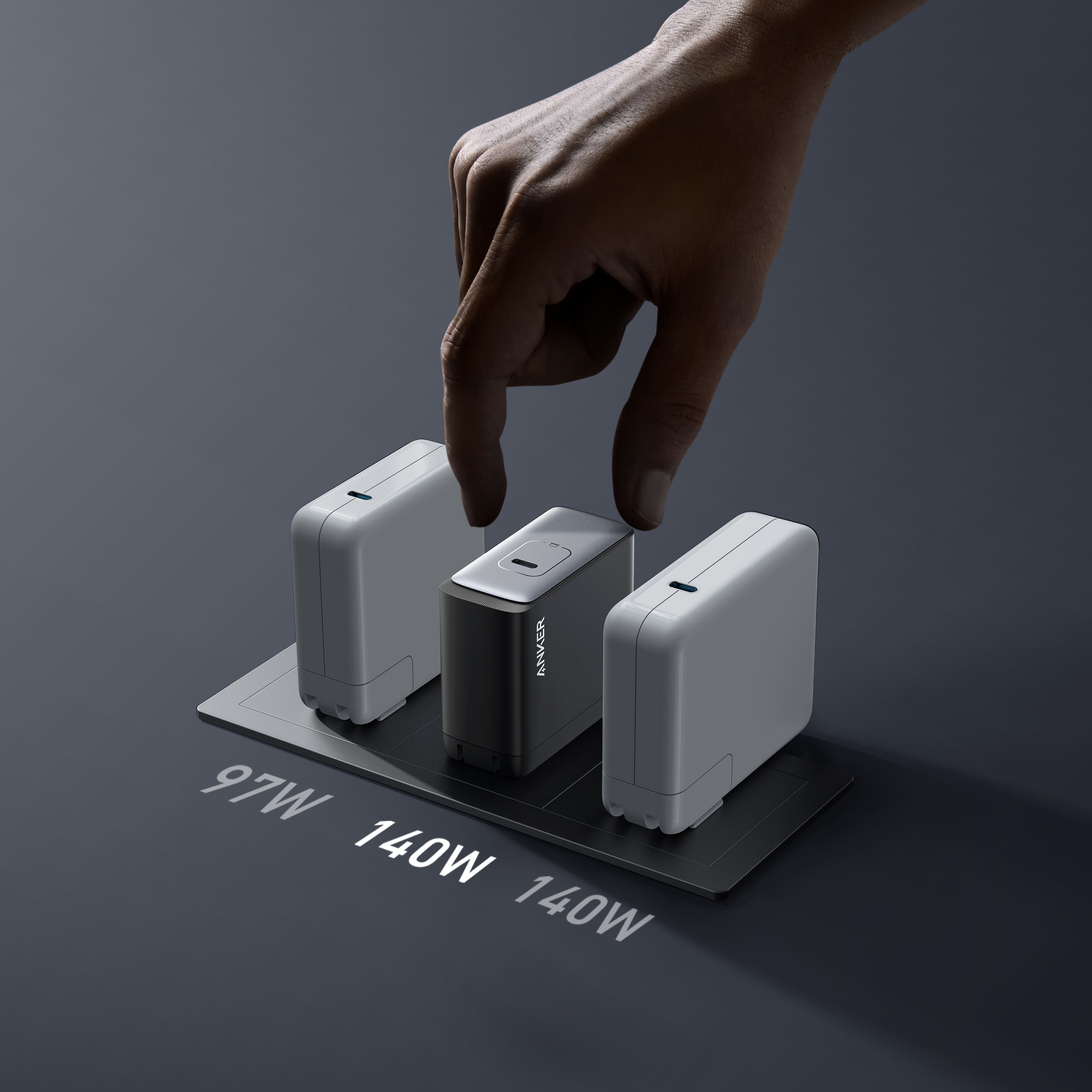 The image features a hand pressing a button on a device, which is likely a power adapter or charger. The device has three different settings, with the largest text reading "140W." The other two settings are 97W and 12W, respectively. The hand is positioned above the device, and the button is located in the middle of the device.