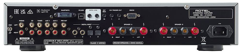 The text on the image reads: "UK EAC PHONO eD Quolcomm X eptXHD TUNER AUEX 1 ALIX 2 BLUETOOTH PRE OUT POUSO ROTEL LIK IN OUT EXT REM IN vSr TRIOGER OUT 1 cesan ROTEL INTEGRATED AMPLFIER MODEL NO. A12MKE POWER CONSUMPTION - 230W OND LEFT DIGITAL INPUT SPEAKER A SPEAKER . RIGHT 2 CAUTION BARUNG SOOR CRGAN 0 N aPEN - 3 - SICTRO Ao  2 DOUBLE INSULATION -When servicing use only identical replacement parts 1 2 CLASS 2 WIRING + RIGHT - LEFT + SPEAKER IMPEDANCE 8 OHMS NOMINAL + RIGHT I - LEFT + A."