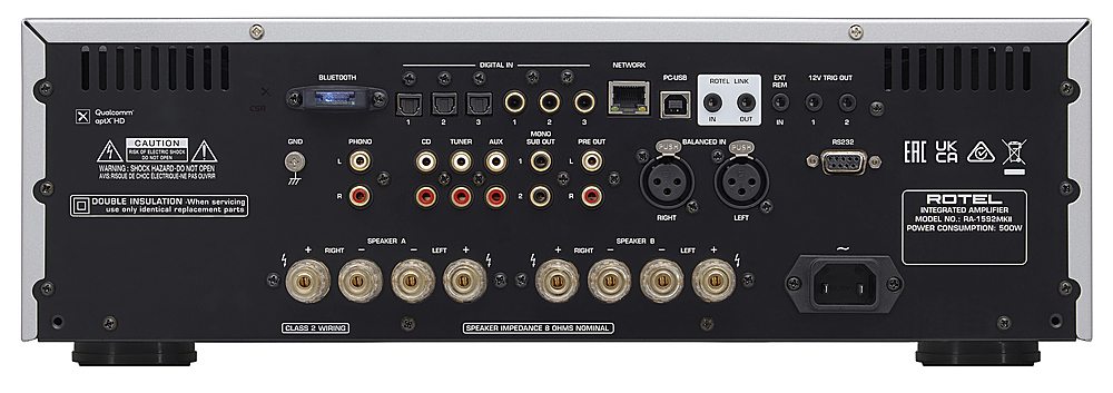 The text on the image reads:
"X BLUETOOTH DIGITAL IN NETWORK POUSB ROTEL LINK EXT REM 12V TIRIC OUT CSR Qualcomm x aptx HD CAUTION 1 - OF ELECTRIC SHOCK I - NOT DRN WARNING SHOCK HAZARD-DO NO NOT OPEN AVS.RSQUE DE CHOC ELECTRIOUE-N PAS OUVRUR DOUBLE INSULATION -When servicing use only identical replacement parts GND TIT 1 PHONO L A SPEAKER RIGHT - 2 3 CD TUNER LEFT AUX 1 2 MONO SUB OUT 1 2 + IN DUT 3 PRE OUT BALANCED IN PUSX PUSM L R RIGHT LEFT SPEAKER . RIGHT LEFT + IN 1 2 RS232 UK EAC CA ROTEL INTEGRATED AMPLIFIER MODEL NO.: RA-1592MKE POWER CONSUMPTION: 500W 18 1 1 I u u I 1 CLASS 2 WIRING SPEAKER IMPEDANCE 8 OHMS NOMINAL"
Corrected text:
"X BLUETOOTH DIGITAL IN NETWORK POUSB ROTEL LINK EXT REM 12V TIRIC OUT CSR Qualcomm x aptx HD CAUTION 1 - OF ELECTRIC SHOCK I - NOT DRN WARNING SHOCK HAZARD-DO NOT OPEN AVS.RSQUE DE CHOC ELECTRIOUE-N PAS OUVRUR DOUBLE INSULATION -When servicing use only identical replacement parts GND TIT 1 PHONO L A SPEAKER RIGHT - 2 3 CD TUNER LEFT AUX 1 2 MONO SUB OUT 1 2 + IN DUT 3 PRE OUT BALANCED IN PUSX PUSM L R RIGHT LEFT SPEAKER . RIGHT LEFT + IN 1 2 RS232