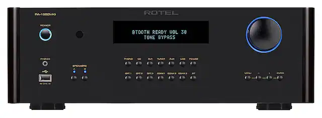 The text on the image reads: "ROTEL POWER AMPLIFIER READY VOL 30 TONE BYPASS PHONES PHONO CD XLF TUNER AUX IN/OUT PC-USB SPEAKERS OPT1 CPT2 OPT COAX1 COAXR COAXS BST MENU ENTER BV DIA -". This text is likely describing the features and capabilities of a Rotel power amplifier.