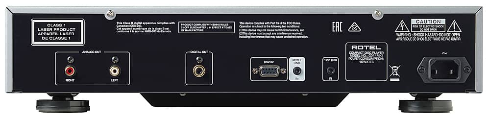 The image features a black electronic device with a label on the back that reads "Class 1 Laser Product." The device complies with Canadian ES-403 and the FCC Rules, Part 15. It is a compact disc player with a power consumption of 15 watts. The device also has a warning label to caution against opening it, as it may pose a risk of electric shock. The device has analog and digital out ports, as well as a RS232 port.