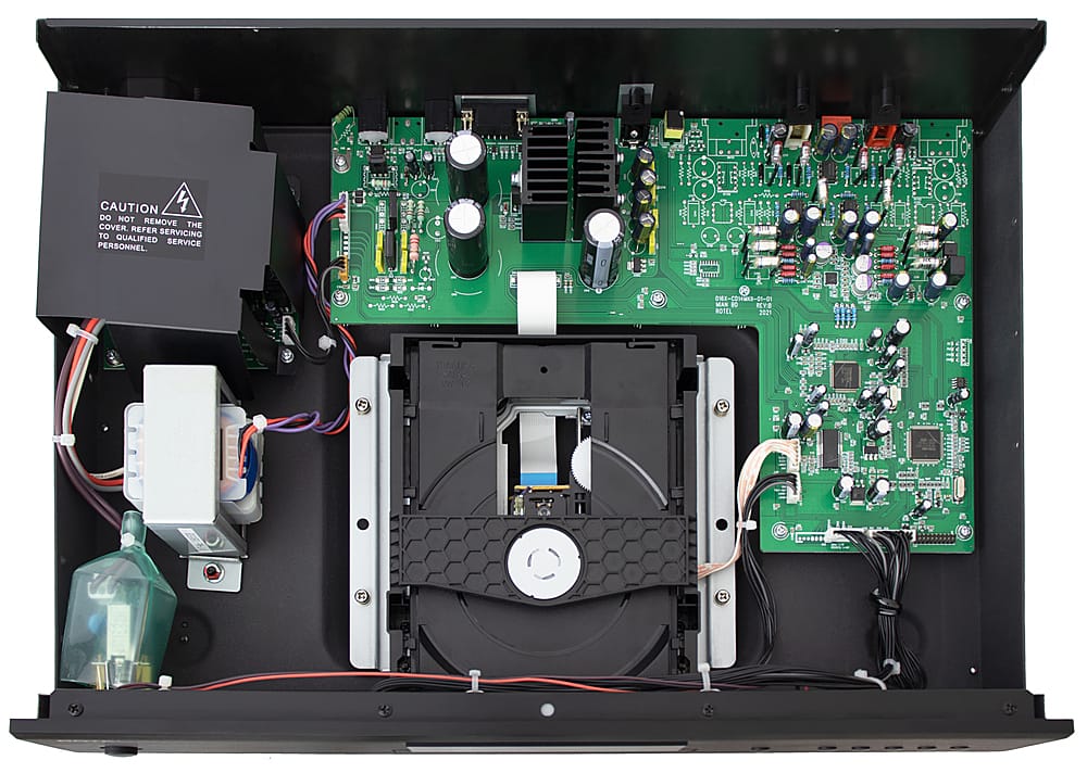 The image shows the inside of an electronic device, possibly a DVD player, with its cover removed. The device is filled with wires and electronic components, including a green circuit board. The image also includes a warning to not remove the cover without qualified personnel, as it could cause damage or pose a safety risk.